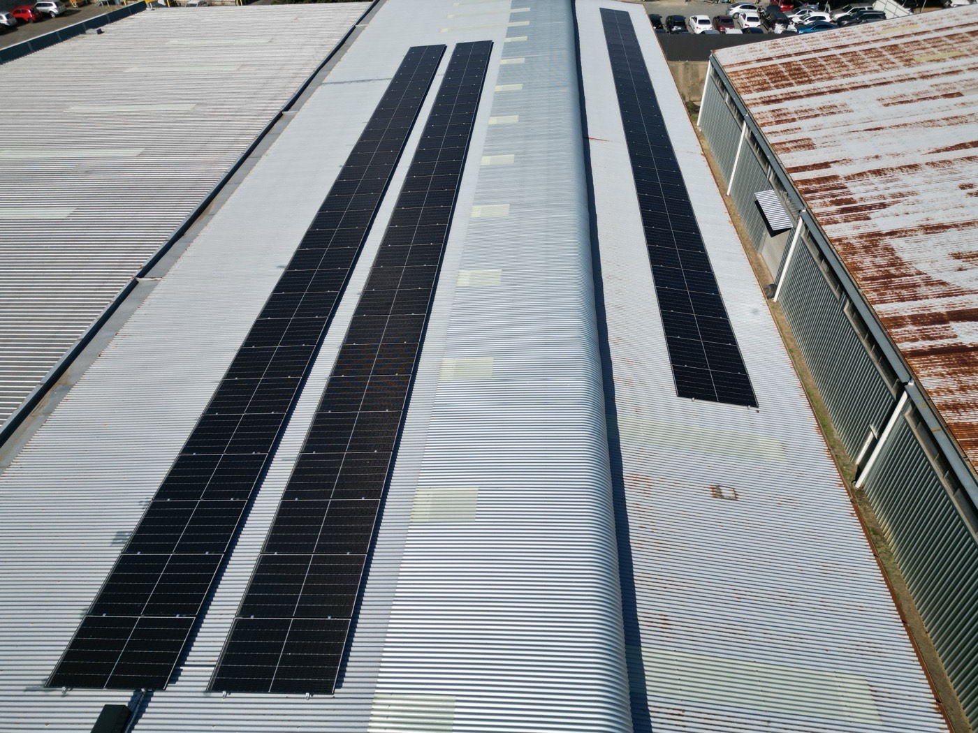 Aerial view of long rows of solar panels on the Fleet Crew warehouse roof