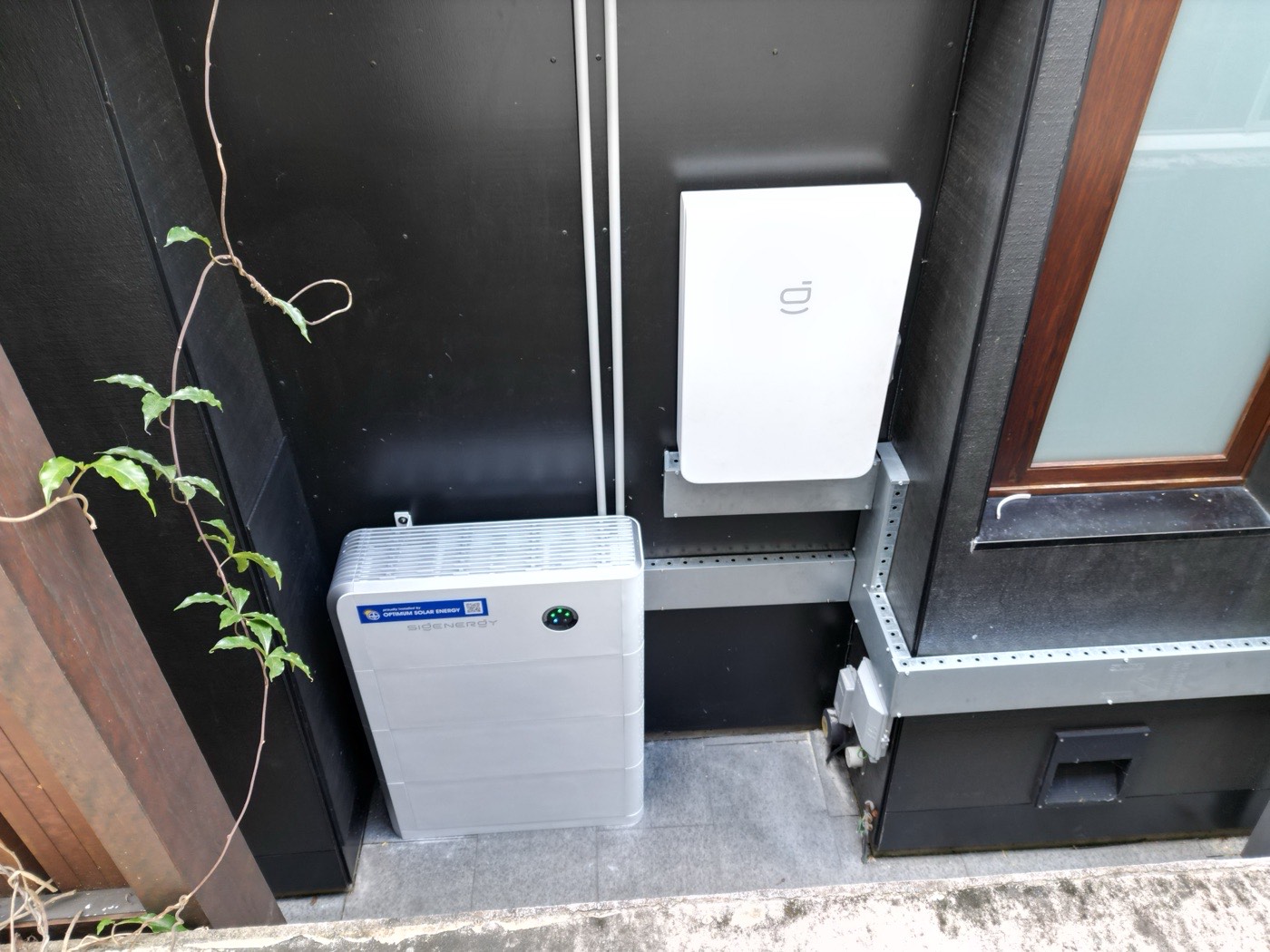 Home battery and inverter installed on an exterior wall