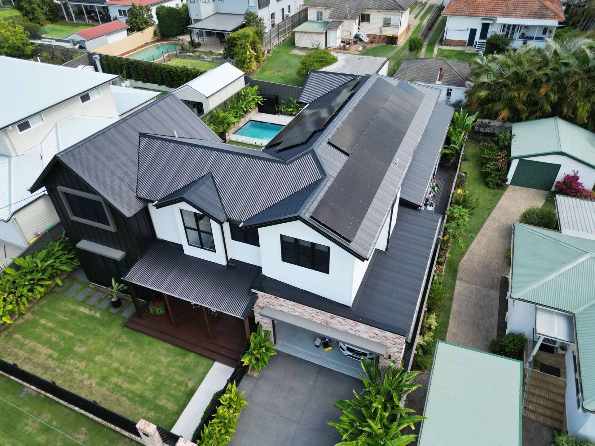 Drone view of a Brisbane home with a rooftop solar system installed by Optimum Solar Energy