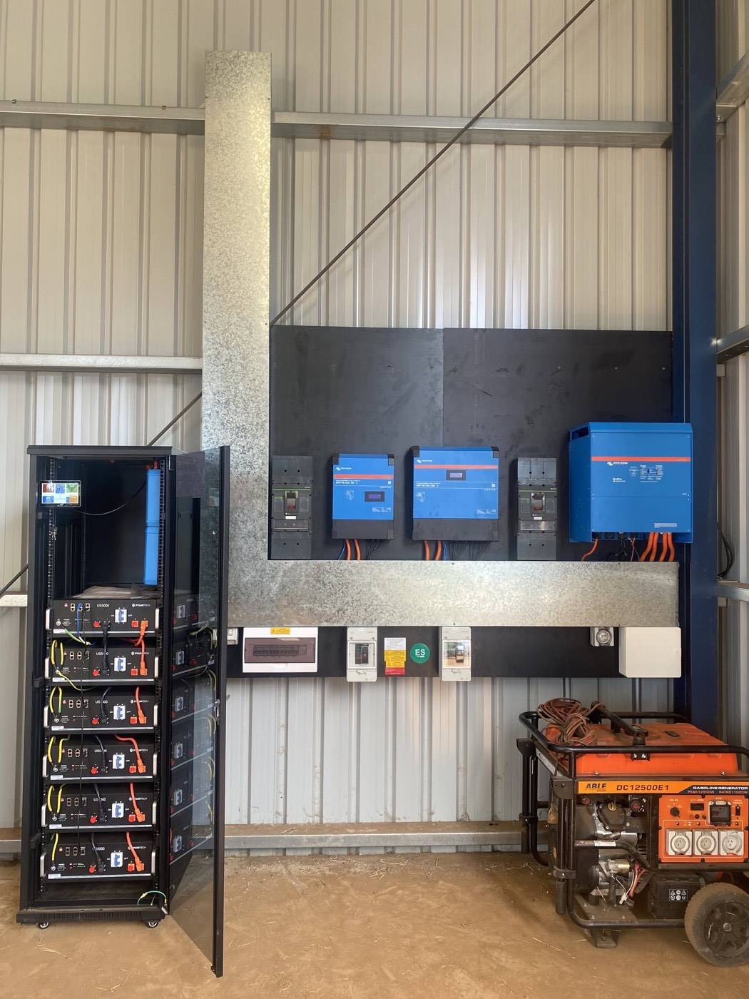 Custom off-grid installation in Minden with Victron inverters on a black ply board, battery rack and backup generator
